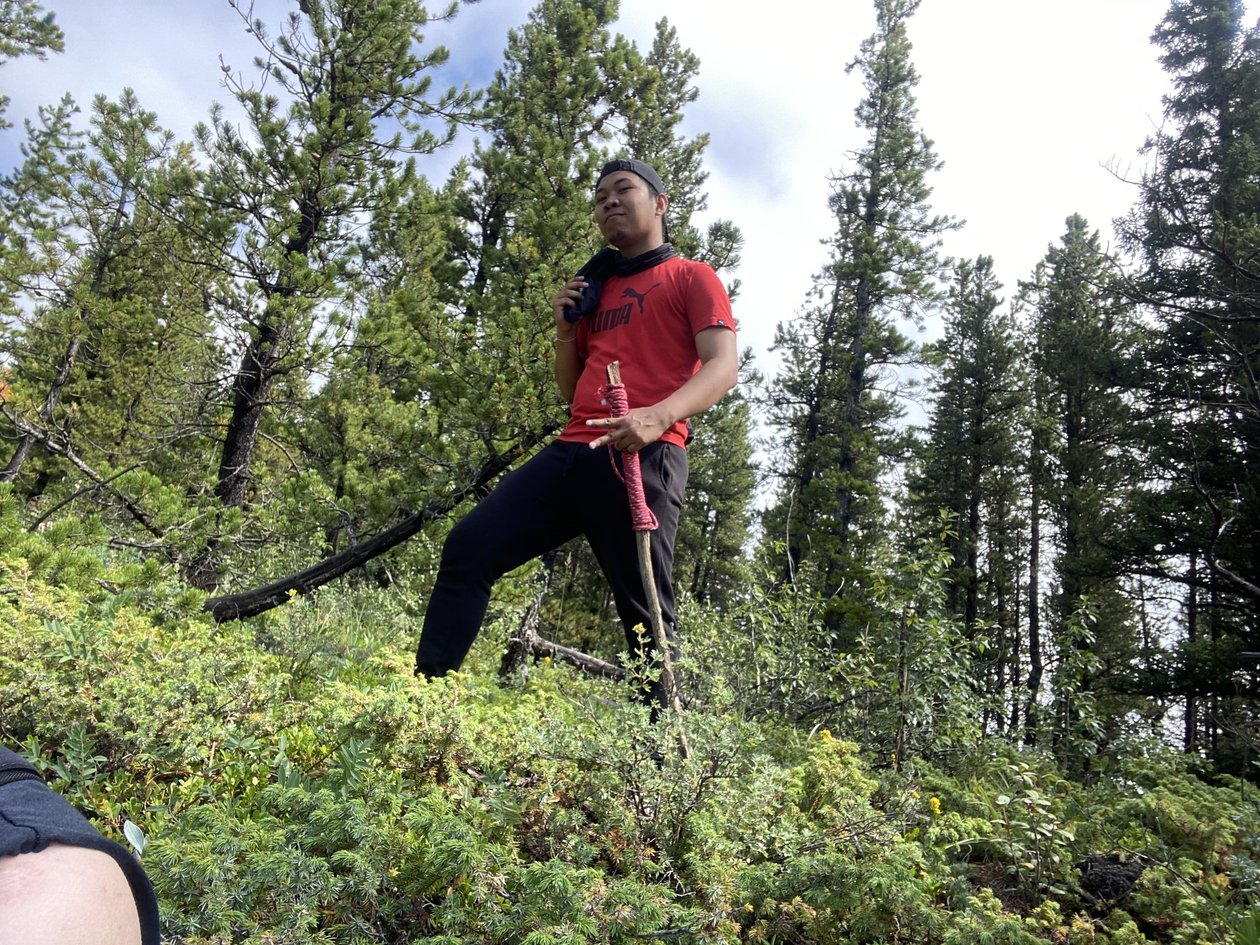 Christian posing in the woods with a fancy red-wrapped walking stick