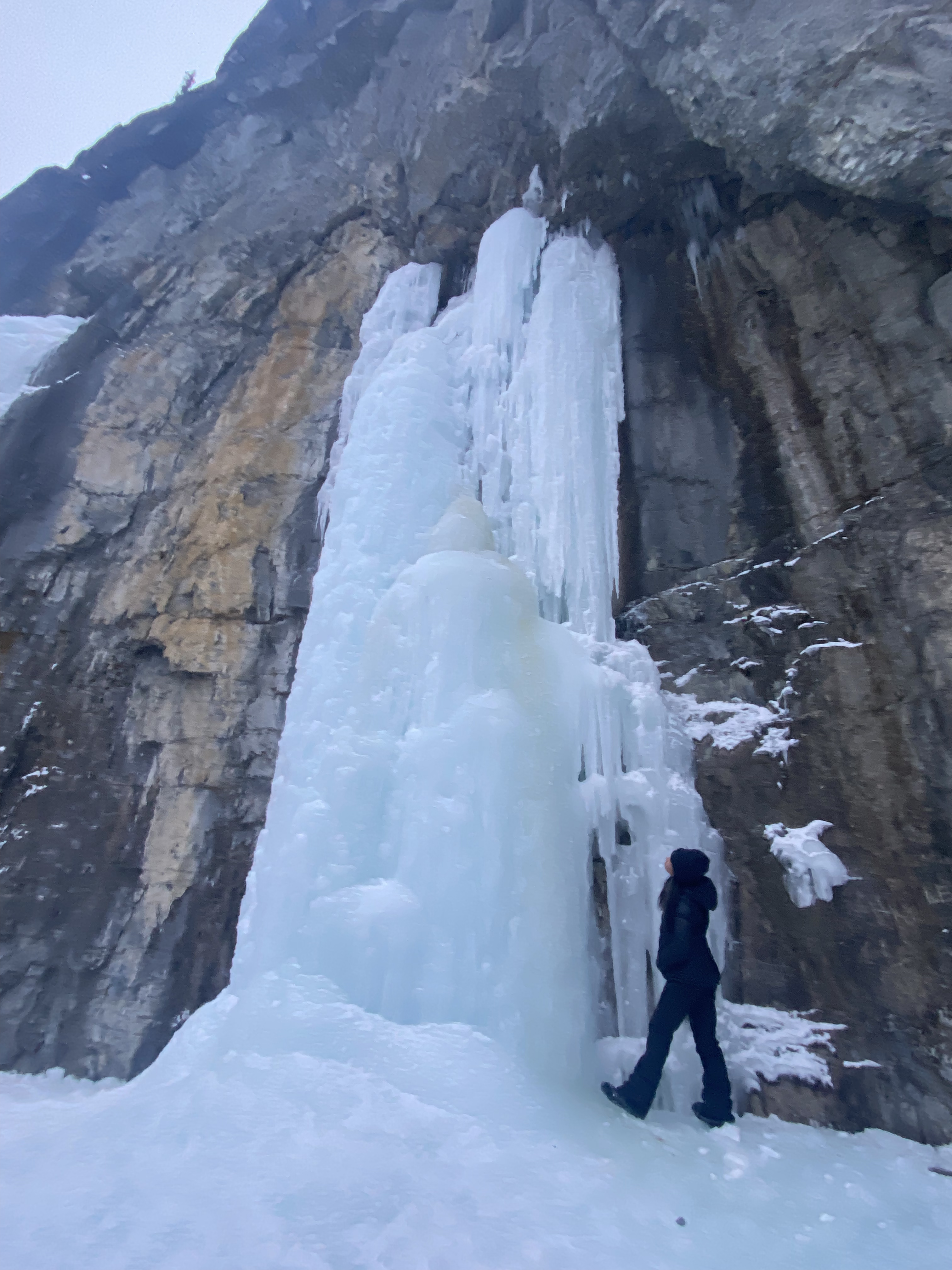 Sarah looking up at the frozen waterfall