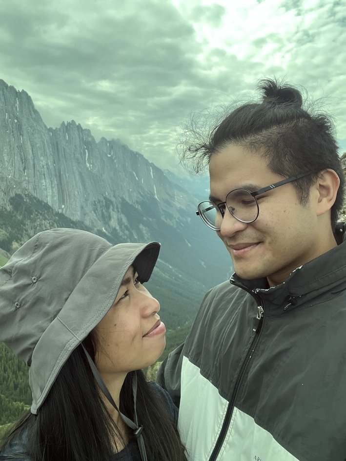 The couple standing on the rocky ridge trail