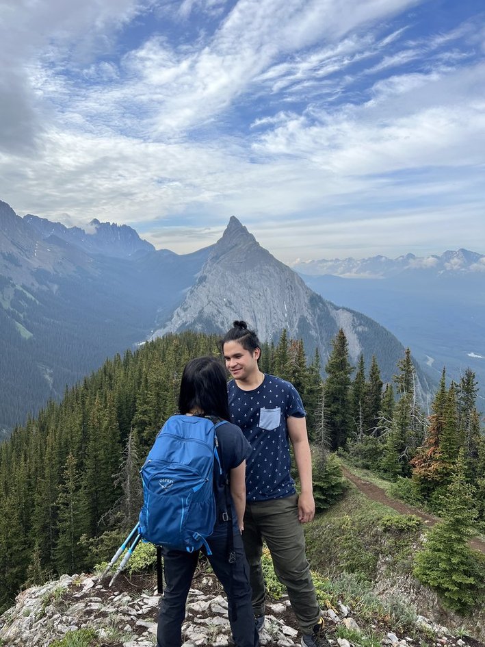Close up of the couple smiling with the mountains behind them