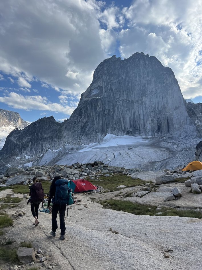 Hiking toward a basecamp below a giant granite spire