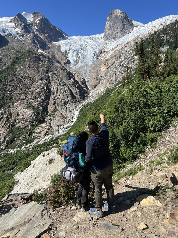 Pointing up at the massive glacier and granite peaks