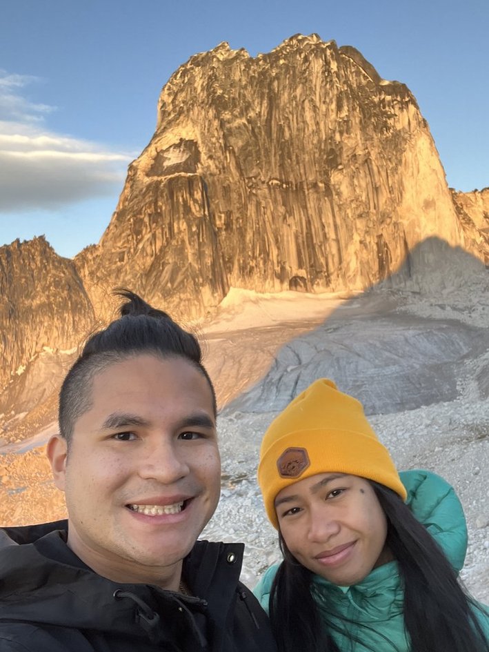 Selfie of the couple with the granite spires glowing in the setting sun
