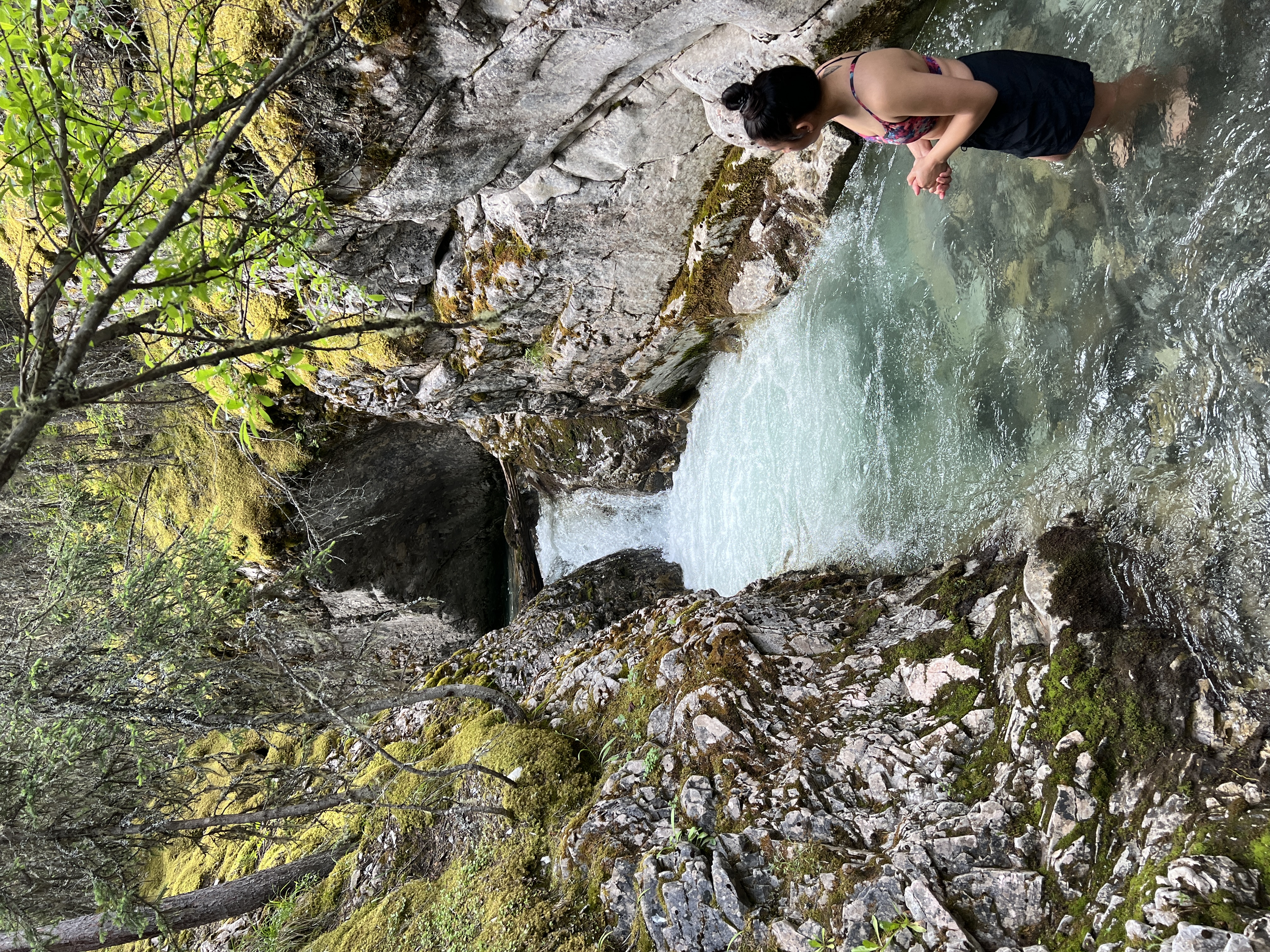 Sarah looking at a stream canyon
